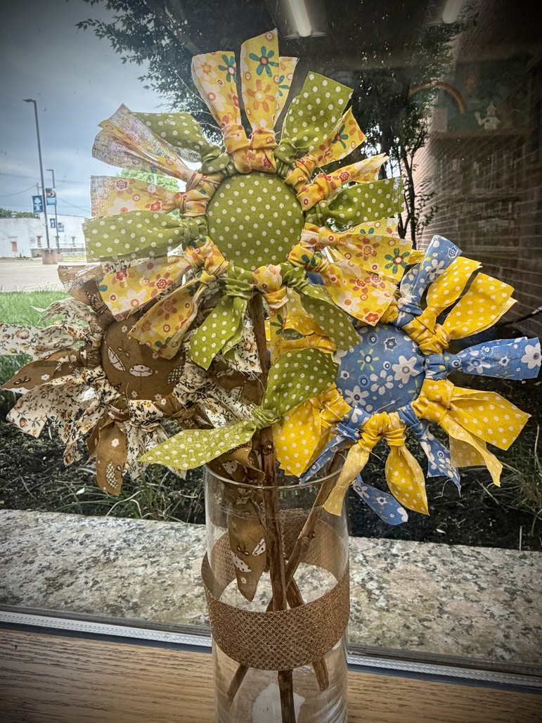 Three fabric flowers in a vase