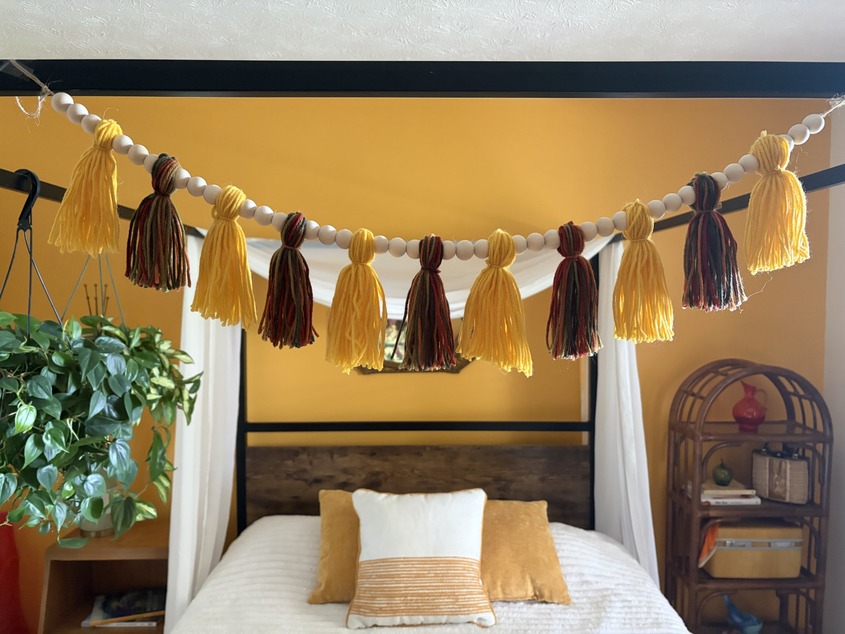Yarn and bead garland hanging from bed posts